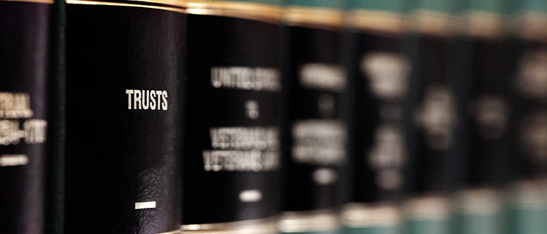 Law Books on Shelf with Labels for Legal Learning Trust and Estate Planning