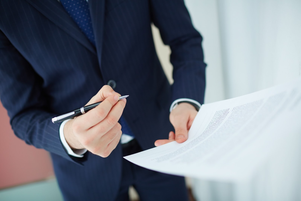 Businessman holding a pen and a contract
