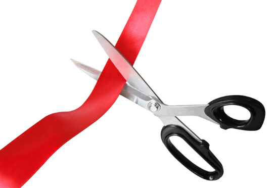 Scissors,Cutting,Through,Red,Ribbon,Or,Tape,,Isolated,On,White.