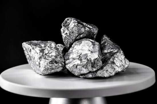 platinum stone, on electronic scale. Metal used in industry. Mineral extraction concept.