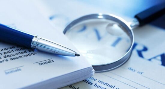 Magnifying-glass-and-pen-on-top-of-contract-GettyImages-1385721977-Med