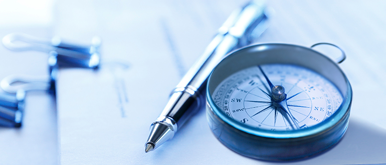 Compass And Pen On Stack Of Legal Documents