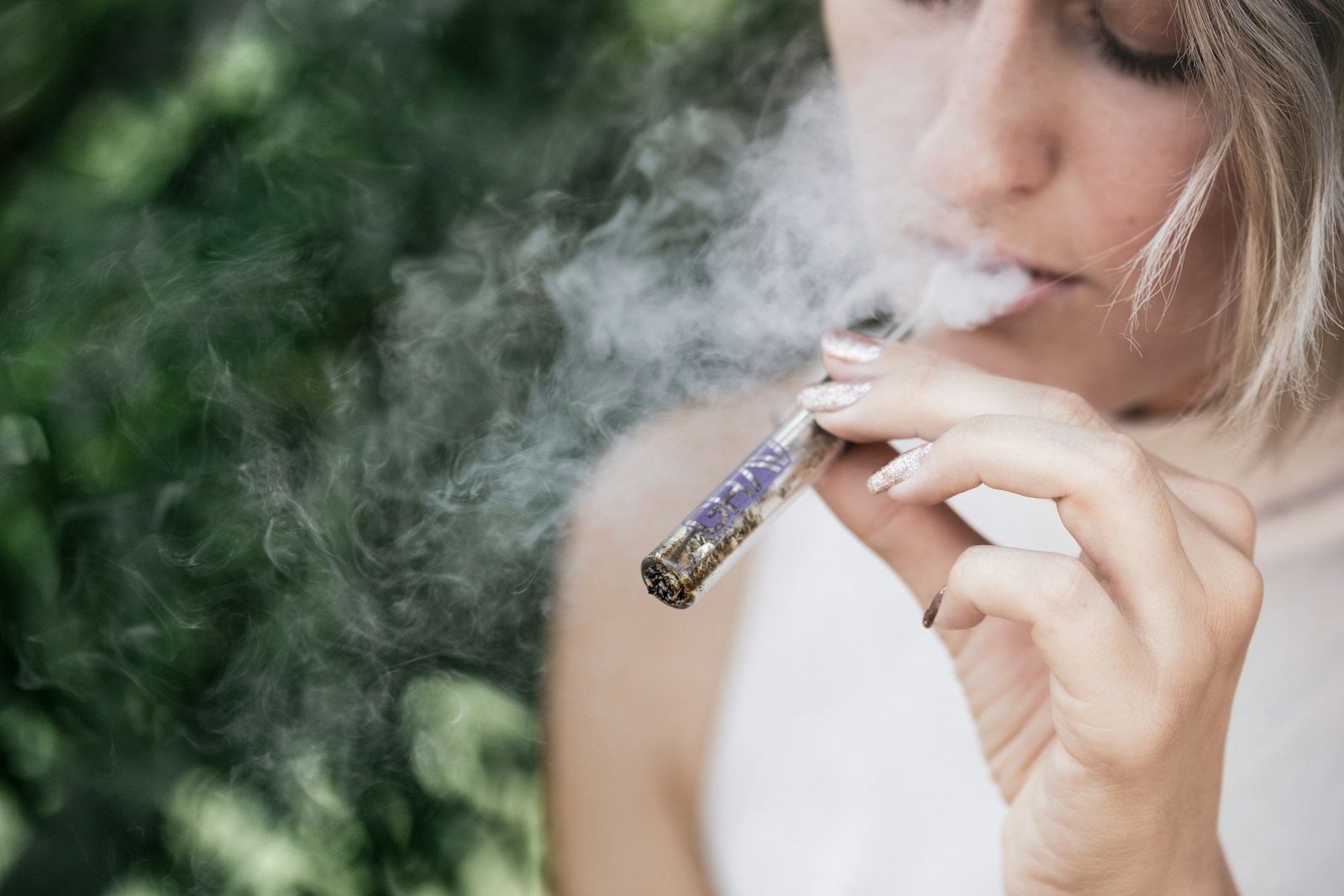 Model smoking a glass blunt.