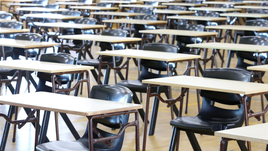 Multiple empty examination tables set up ready for Yr12 or Form 6 University entrance exams. school leavers certificate. bar exam illinois