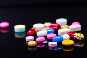 Colorful pills over dark background