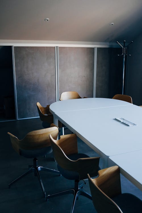 Free From above of stylish interior of modern conference hall with comfortable chairs and oval table Stock Photo