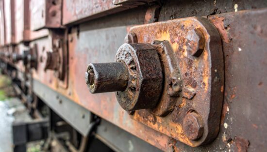 Close-up of rusty metal coupling on a freight train