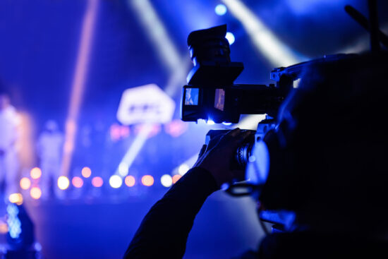 Professional TV cameraman during event recording