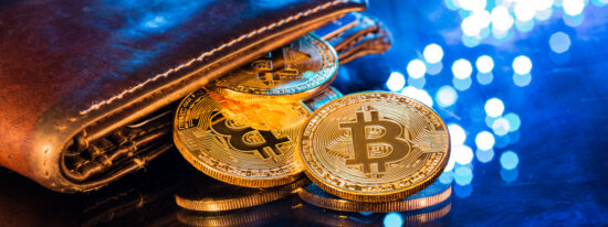 Bitcoin gold coins with wallet, close-up Virtual cryptocurrency concept