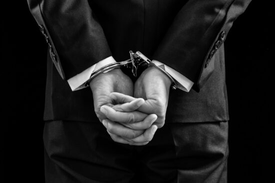 Arrested,Business,Man,Handcuffed,Hands,At,The,Back.black,And,White