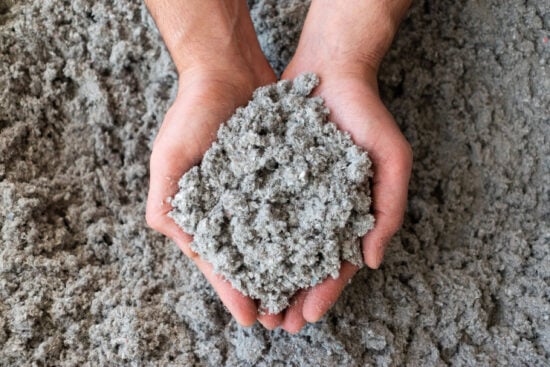 Close shot of eco friendly cellulose insulation filling held in