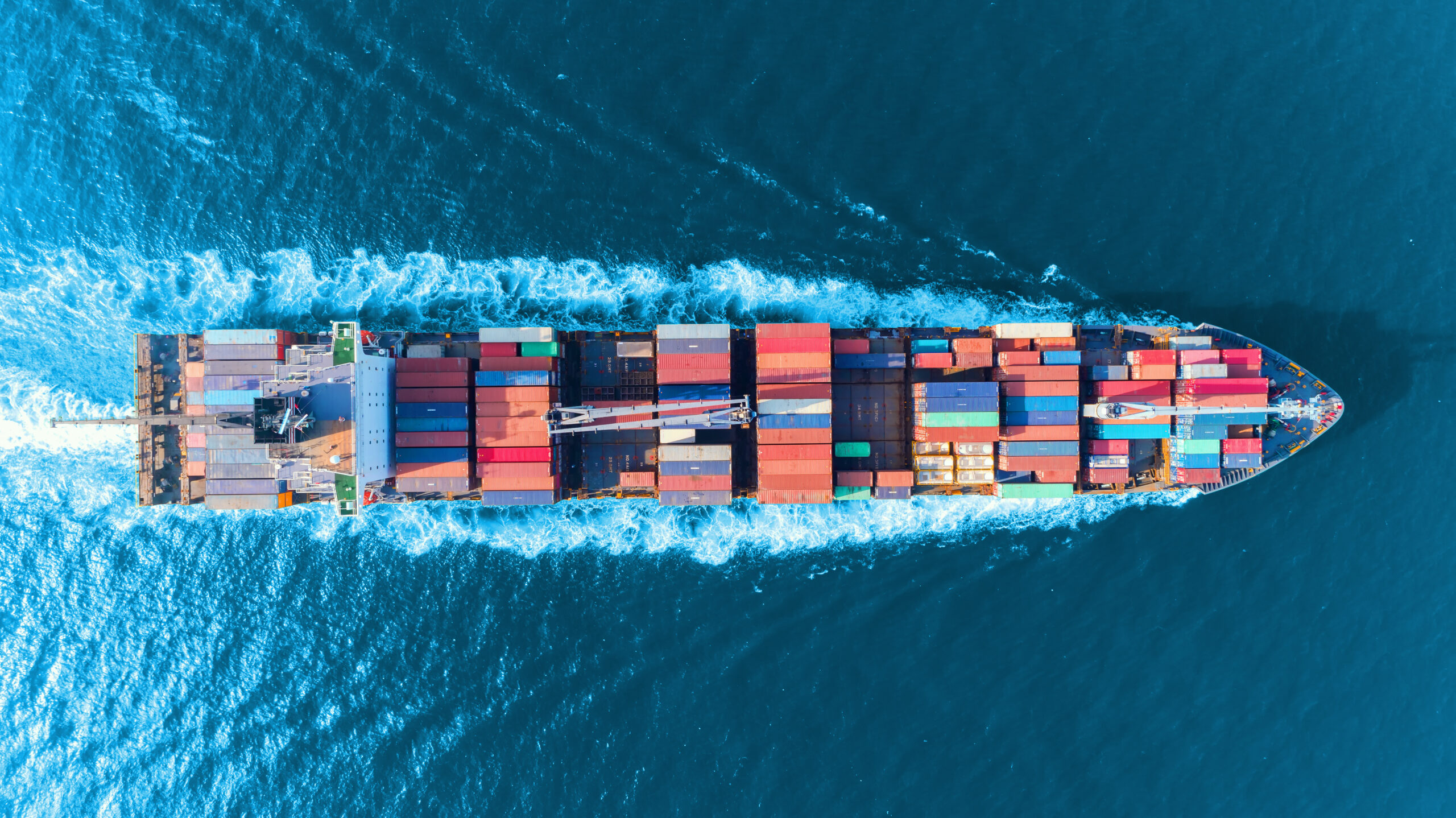 Aerial top view full speed container ship in the sea for logisti