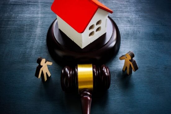 Figurines,,Model,Of,A,House,And,A,Gavel,,As,A