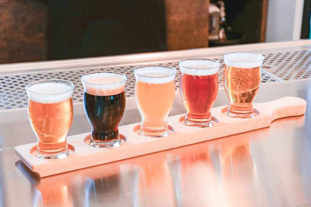 row of beverages on wooden plank