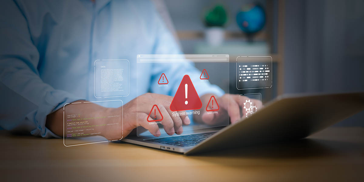 Cybersecurity, virus protection, Hand on laptop with holographic System warning and red alert icons. Symbolizes cyber threats, data security breaches, and IT system errors. digital risk management now