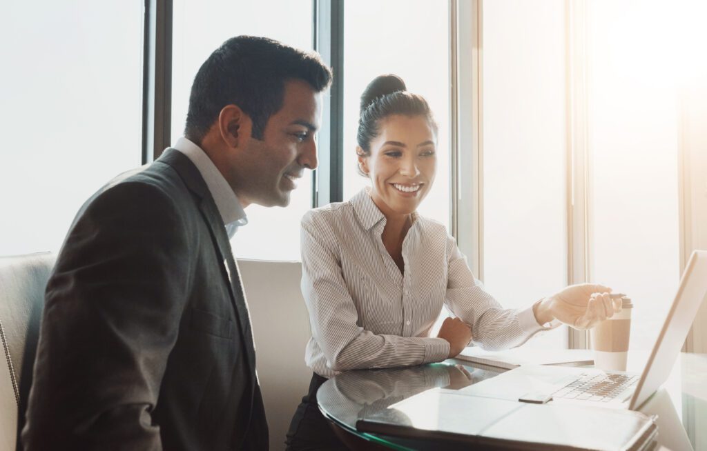 Attorney, teamwork and meeting with laptop in office for legal case brainstorming and client defence discussion. Happy lawyer people, tech and collaboration at law firm with online contract policy, hispanic heritage month lawyers