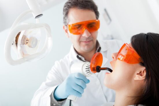https-www-911victimlawyer-com-hubfs-dentist%20fixing%20a%20cavity%20on%20a%20female%20patient%20using%20laser-jpeg