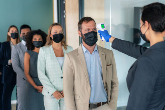 Business people measuring temperature in the office