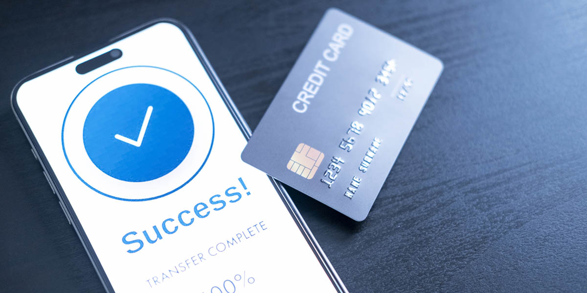 smartphone screen shows a successful payment confirmation, with a credit card. The image emphasizes digital payments, financial technology, and the convenience of secure mobile transactions.