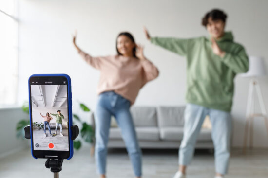 Millennial Asian Couple Dances and Vlogs at Home, Capturing Fun Moments on Smartphone