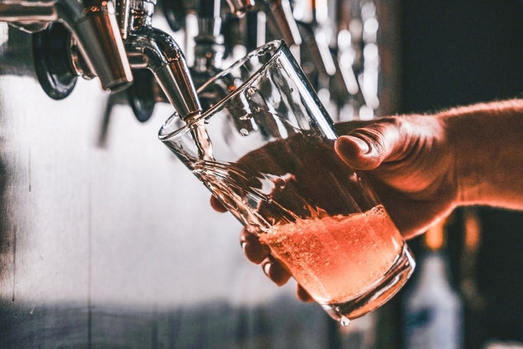 beer being poured into a glass