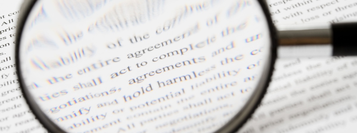 contract fine print magnifying glass Shutterstock_34559689