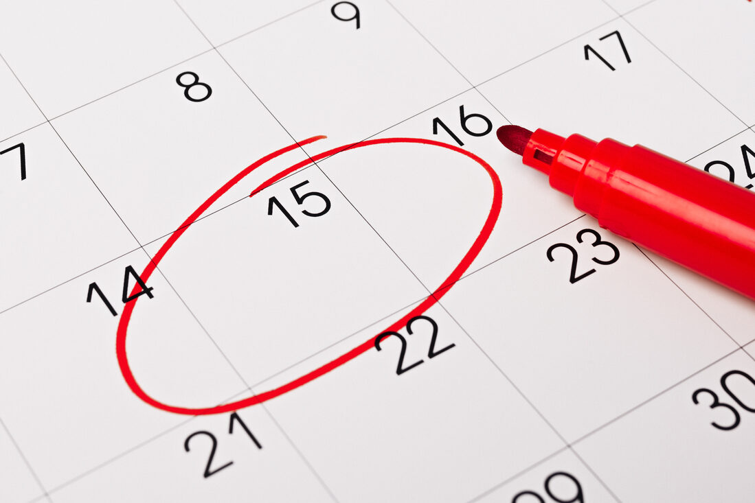 Calendar page with red pen close up. Focus on number 15 in calendar and empty red circle for design in your ideas and work concept