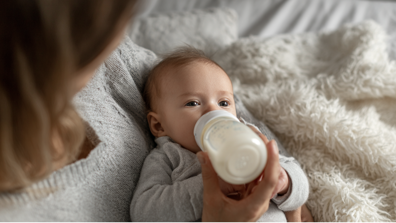 mom feeding baby with bottle