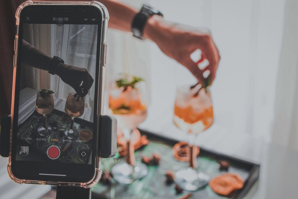 person taking a video of drinks