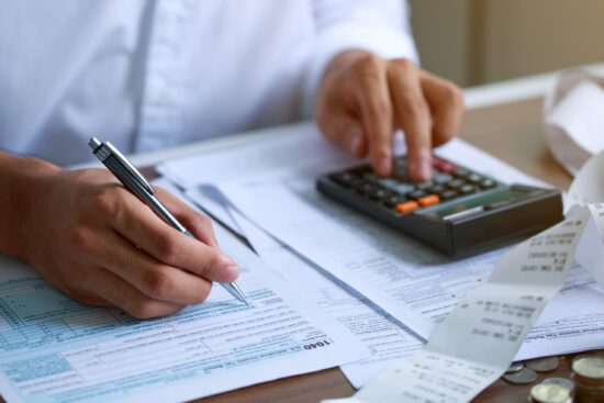 Man,Hand,Filling,Us,Tax,Form.,Tax,Form,Us,Business