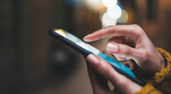 point finger on screen phone closeup, person texting text messag