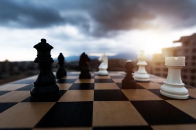 https-esquireglobalcrossings-squirepattonboggsblogs-com-wp-content-uploads-sites-21-2026-02-black-and-white-chess-pieces-battle-on-the-board-gettyimages-1404218595-jpg