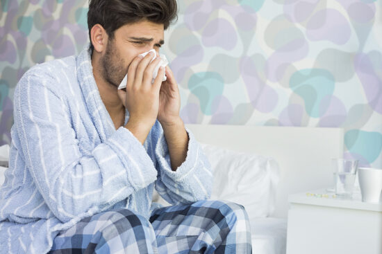 https-www-njemploymentlawfirmblog-com-files-2026-02-bigstock-sick-man-blowing-his-nose-in-t-71584990-jpg