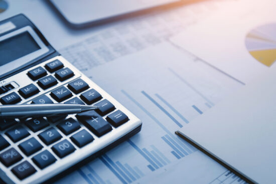 finance accounting concept. pen and calculator on table