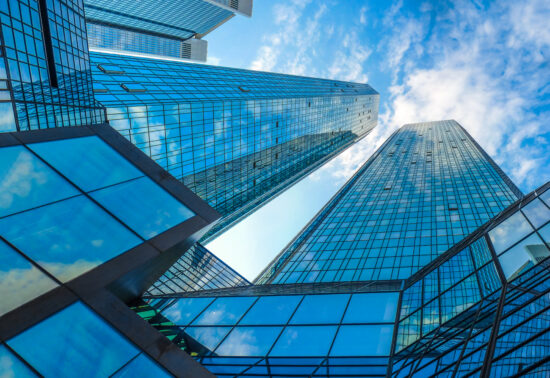 Modern skyscrapers in business district against blue sky