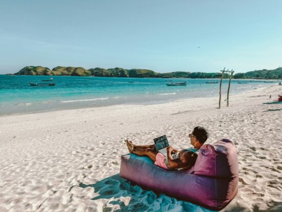 Relaxing on a beach in Lombok with my laptop out.