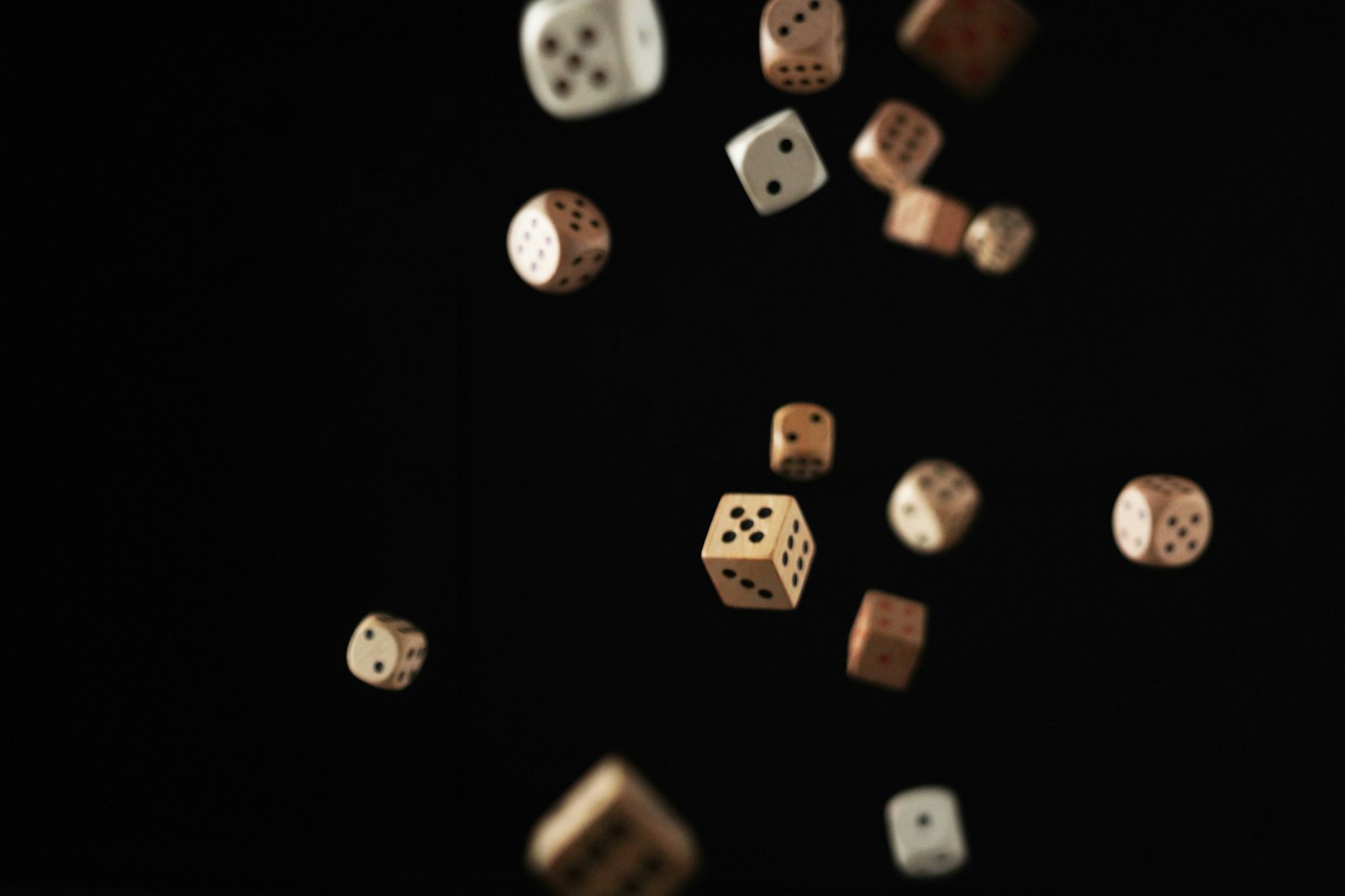 Dice falling on a black background.
