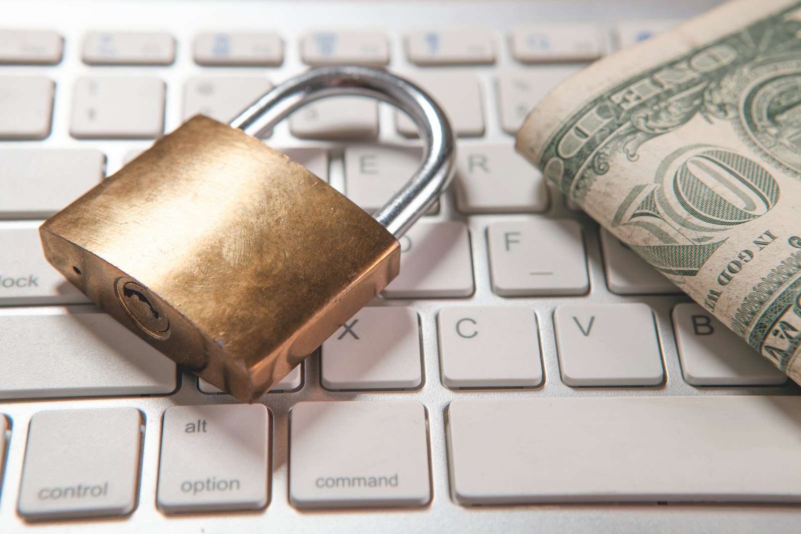 lock with a dollar symbol and a keyboard on the table.
