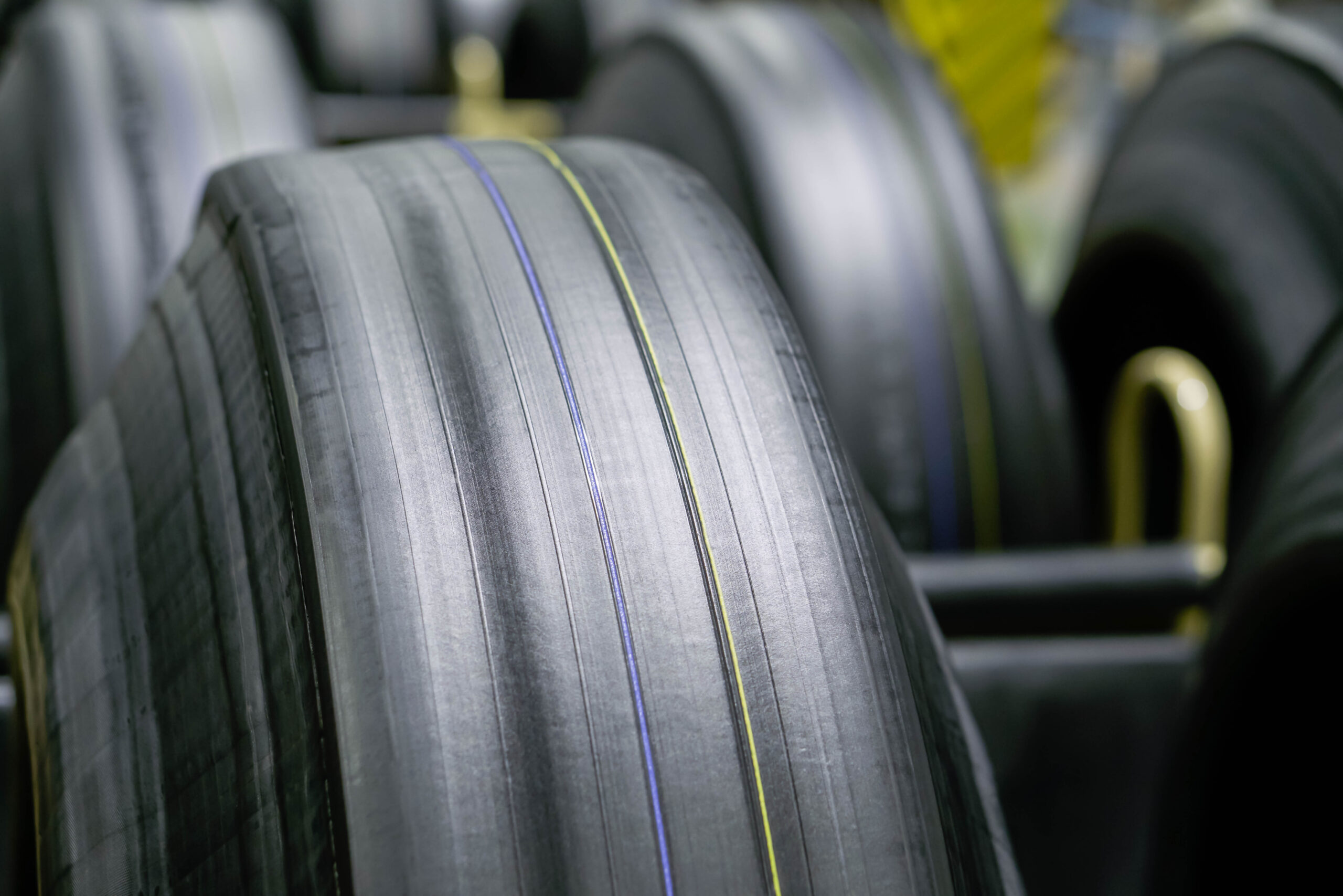 Tyre manufacturing production in factory warehouse, Green tire radial, extruded rubber layers preparing to mold for the curing process, car logistic transportation industry