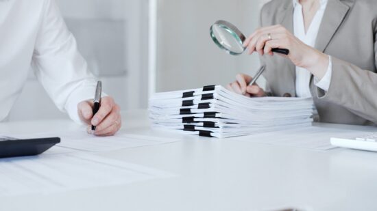 Auditors,And,Financial,Experts,Analyzing,Tax,Documents,,Reviewing,Contract,Papers,