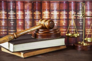 https-bamandgadsolicitors-com-ng-wp-content-uploads-2026-05-soundblock-wood-scales-books-stack-background-leather-300x200-webp