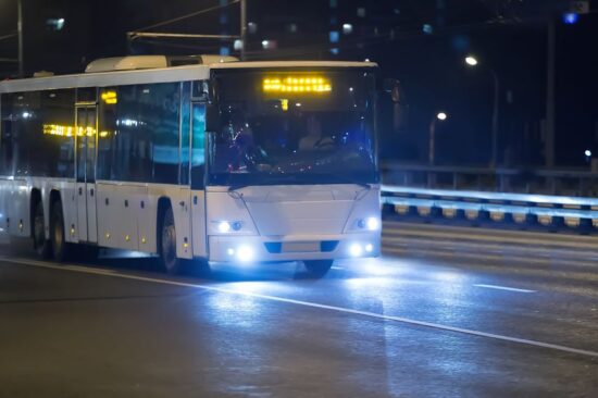 87008454 - bus moves on city street at night