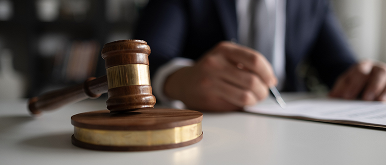 Judge or Legal advisor lawyer examining and signing legal documents.