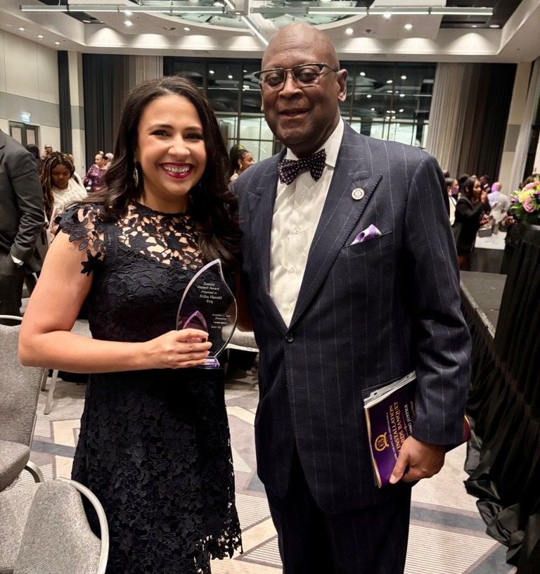 Chief Justice P. Scott Neville and Erika Harold pose at the CCBA Awards. Erika holds her award.