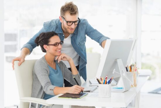 https-www-xakiatech-com-hubfs-young%20design%20team%20working%20at%20desk%20in%20creative%20office-jpeg