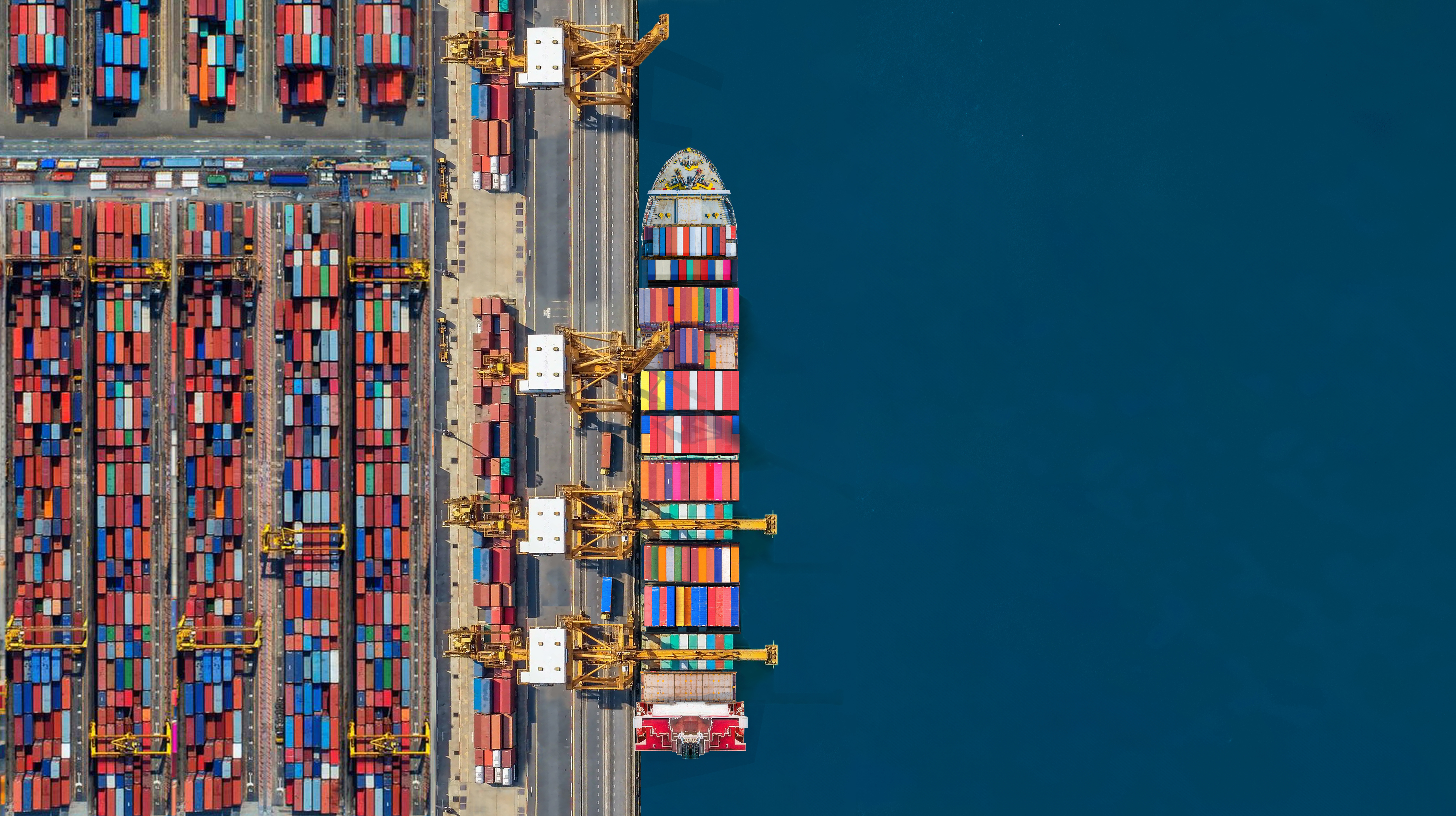 Industrial import-export port prepare to load containers. Aerial top view container ship in export and import global business and logistic. Global transportation and logistic business.