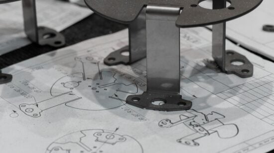 Every detail matters. A manufactured component is verified against its original schematics, ensuring perfect adherence to the design intent. https://www.encata.net/services/mechanical-engineering-services?utm_source=unsplash&utm_medium=organic&utm_content=image