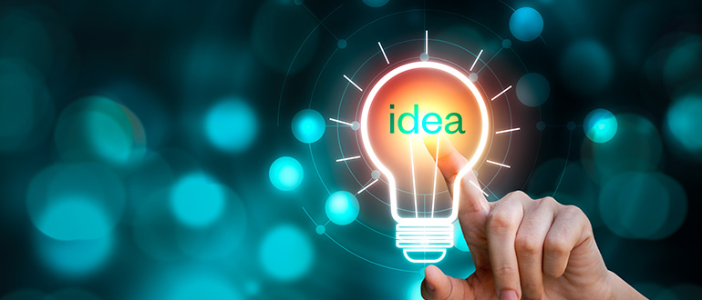 Hand touching the light bulb sign with idea text on blurred background. Creative innovation