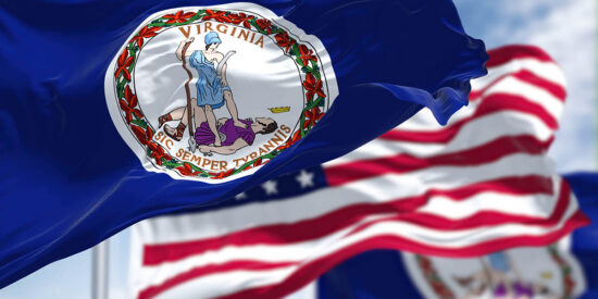 The Virginia state flag waving along with the national flag of the United States of America