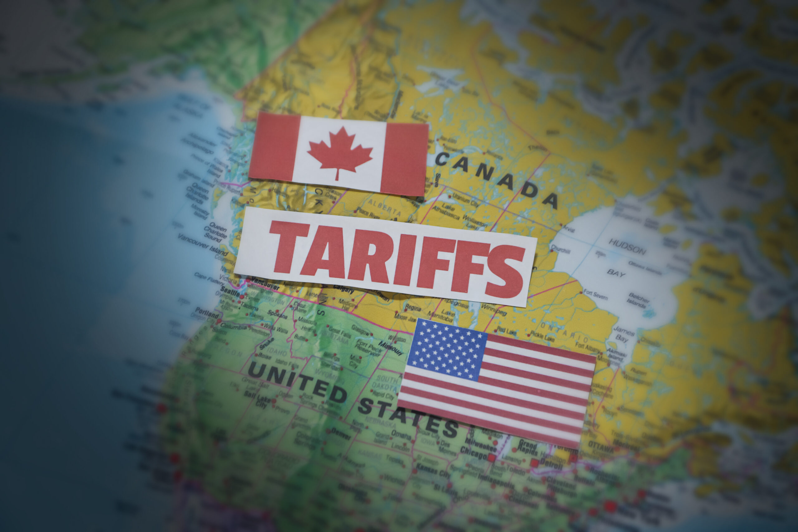 Canada and United States Tariff war concept background with flag and map along typography. Trade, usa, canada, business, tax, import